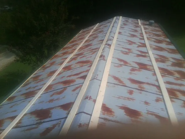 Rusted metal roof panels with new wood purlins before replacement — Storm Damage Roof Repair in Village Mills by Roofing Brothers